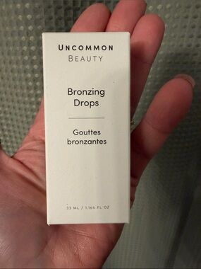Uncommon Beauty Bronzing Drops — cream white